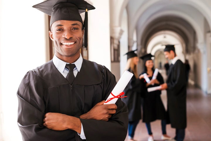 college graduate holding his diploma | Competition Subaru of Smithtown in St James NY