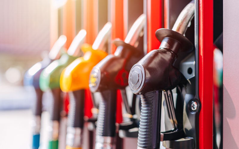 Fuel pump nozzles at a gas station, representing vehicle refueling and fuel system services