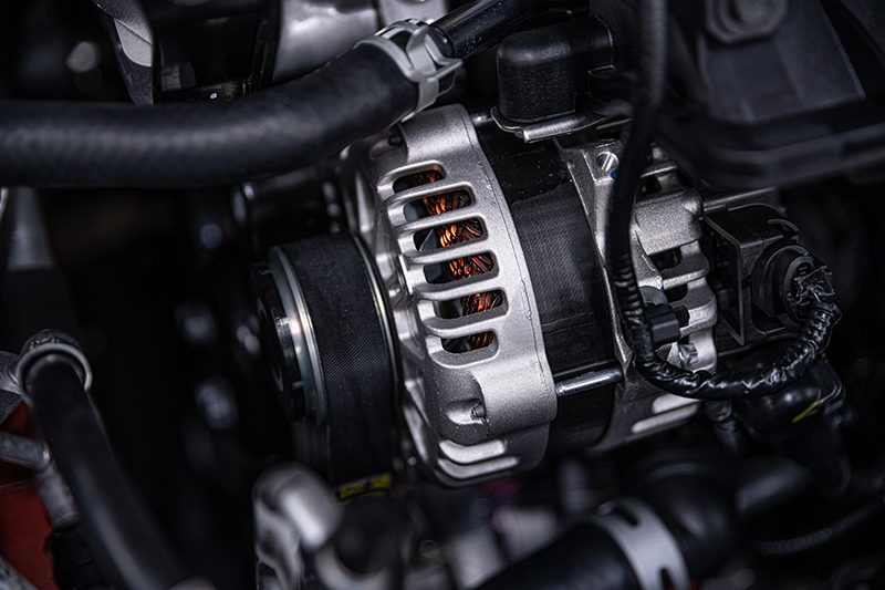 Automotive alternator mounted in a vehicle engine bay as part of the charging system